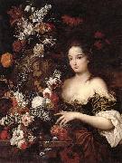 A still life of various flowers with a young lady beside an urn